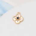 Detailed close-up of gold plated shell four-leaf clover pendant with blue stone inlay - 32#13*16mm