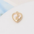 Macro detail of gold-plated heart pendant with rabbit inlay and beaded frame finish - 34#13*15mm