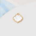 Macro shot of gold-plated clover pendant with natural white shell and hanging loop - 35#13*14mm