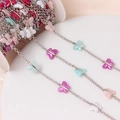 Close-up of DIY jewelry making chain with colorful acrylic butterflies and silver links - White K Plated Multicolor Butterfly