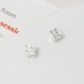 Macro shot of silver floral spacer beads with four petals and cross-etched flower centers - Silver Four-Petal Flower Style (05#)