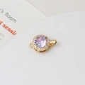 Macro view of gold-plated round clasp featuring a purple zircon and white crystal accents - Light Purple Round (10x15mm)
