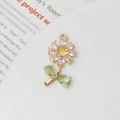 Macro shot of gold daisy flower pendant with sparkling cubic zirconia and green leaves - Yellow Center Daisy Style (06#14*28mm)