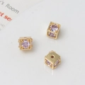 Detailed macro view of 18k gold plated cube beads with purple cubic zirconia for DIY - 6mm / Gold/Light Purple