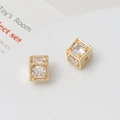 Macro shot of a 18k gold plated hollow cube bead with cubic zirconia for jewelry making - 8mm / Gold/White