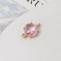 Close-up of pink faceted gemstone connector with gold metal frame for DIY jewelry making - Pink