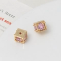 Macro shot of 18k gold plated cube beads with pink zircon inlay for jewelry making - 8mm / Gold/Pink