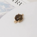Vue macro d'un connecteur quartz fumé taille coussin avec sertissage à quatre griffes doré - Vert olive