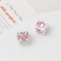 Macro detail of cube-shaped pink zircon beads with silver plated 18k gold frames - 10mm / Silver/Pink
