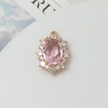 Detailed macro view of 10x14mm oval pink crystal pendant with gold plated stone setting - Light Pink