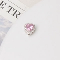 Macro view of heart-shaped charm with pink zircon inlay and pavé set border - 10mm / Silver Plated Pink