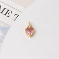 Macro shot of gold-plated heart pendant with pink zircon for DIY necklace jewelry - Pink Heart
