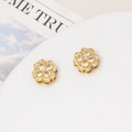 Detailed view of gold four-leaf flower charms with micro-paved zircons on a white tray - Clover Spacer Bead / 12mm / Gold-White