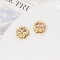 Macro shot of two gold four-leaf clover charms with purple zircon and pave crystal details - Clover Spacer Bead / 12mm / Gold-Light Purple