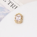 Detailed macro view of a gold-plated rectangular pendant with micro-pave zircon crystals - White