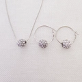 Dettaglio del set di gioielli argentati con pendenti a sfera di cristallo su rete bianca - Set di gioielli / Bianco