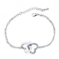 Silver interlocking heart bracelet featuring sparkling blue crystal pavé accents - Light Blue