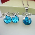 Elegant bow-shaped jewelry set with royal blue round crystals and silver finish - Aqua