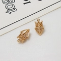 Detailed close-up of golden crown pendants with hollow weaving and clear zircon stones - Crown Style (LF2689-01)