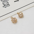 Macro shot of a hollow geometric gold pendant with a shimmering cubic zirconia stone - Rhombus Style (LF2689-04)