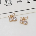 Close-up of gold cherry pendants with inlaid zircon crystals on a white fabric background - Clear Cherry (05#)