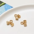 Detailed view of DIY gold brass lotus pod and fortune bag charms in a ceramic tray - Lotus Pod and Bud (01#) / Retail Price