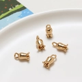 Detailed view of five golden lily of the valley flower pendants on a white plate - Magnolia Flower (04#) / Retail Price