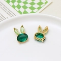 Macro view of emerald green rabbit-shaped crystal pendant with gold-toned filigree base - Rabbit Style / Green
