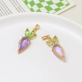 Detailed view of two purple crystal carrot pendants with green leaves and gold metal clasps - Carrot Style / Purple