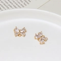 Close-up of golden butterfly charms with zircon crystals for DIY jewelry making - Vibrant Butterfly Style (03)
