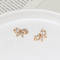 Macro view of gold bow-shaped butterfly jewelry connectors with heart zircon crystals - Double Wing Butterfly Style (04)