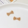 Macro shot of two golden bow pendants with micro-pave zircons for DIY jewelry making - Bowknot Style (03#10*17mm)