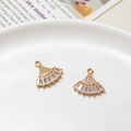Vue détaillée de deux pendentifs éventails dorés sertis de zircons sur un plateau blanc - Style Éventail Micro-pavé à Trou Unique (05#16*16mm)