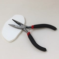 Detail shot of long-nose pliers with anti-slip teeth and ergonomic black and red handles - Needle Nose Pliers (With Teeth)