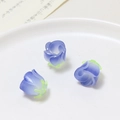 Macro shot of three purple gradient resin rose beads for DIY jewelry making accessories - Blue