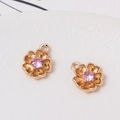 Close-up of golden floral pendants with pink zircon centers for DIY jewelry making - Tier 1 (Min 2 Pcs) / Style 02 (Small Pink Gem Floral) (LF2840) / 11*14mm