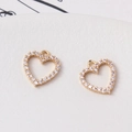 Close-up of heart-shaped gold pendants with cubic zirconia for jewelry making - 12*13mm