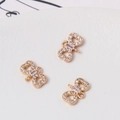 Close-up of golden bow jewelry charms with cubic zirconia for DIY bracelets - 8*12mm