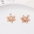 Macro detail of two snowflake pendants with cubic zirconia for DIY jewelry making - Style 02 (16*20mm)