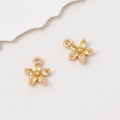 Macro view of five-petal flower charms with yellow pear-shaped stones and gold settings - 8*10mm / Yellow