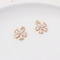 Macro detail of gold-plated five-petal flower pendants with drop-shaped zircon inlays - Minimum 2 Pieces / Style 03 (11x13mm)