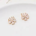 Macro shot of two gold-plated daisy flower pendants with clear zircon petals and jump rings - Minimum 2 Pieces / Style 02 (11x13mm)