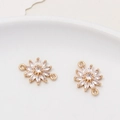 Detailed macro view of daisy-shaped gold-plated connectors with zircon petals for DIY jewelry - Style 06 (12x17mm)