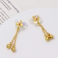 Detailed shot of iridescent butterfly charms with gold chains, bells, and red crystal accents - Aurora Color