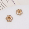 Macro detail of two gold-plated flower spacers with micro-pave cubic zirconia for DIY jewelry - 01# (10mm)