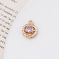 Makroaufnahme von goldenem Anhänger mit lila Zirkonia und weißem Diamantenkranz - Hellviolett