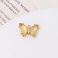 Macro shot of gold butterfly pendant with yellow zircon crystals on white background - Light Yellow