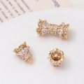 Detailed macro view of 14K gold-plated screw clasps with cubic zirconia and pearl settings - Crown Bud Threaded Connector / 14K Gold-White Zirconia