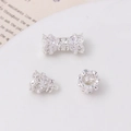 Detail of 14K gold-plated copper screw clasp with zircon inlay for DIY jewelry - Bow Shape Magnetic Connector / Silver-White Zirconia
