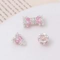 Pink heart-shaped jewelry clasp with zircon and silver base on a ceramic tray - Silver-Pink Zirconia